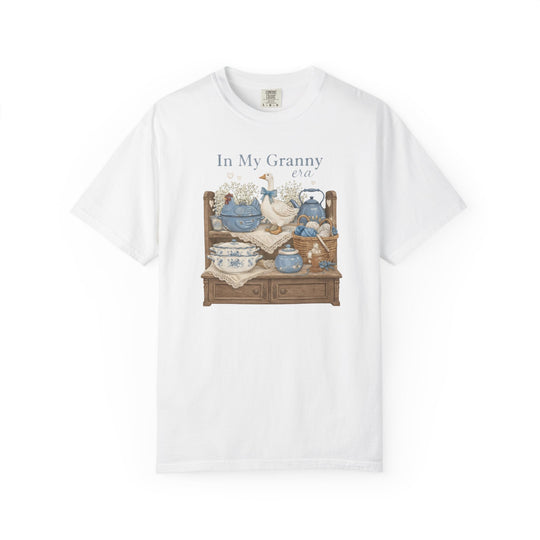 “In My Granny Era Tee” features vintage-style decor graphic on white short-sleeve, offering a cozy, durable fit with 100% ring-spun cotton.