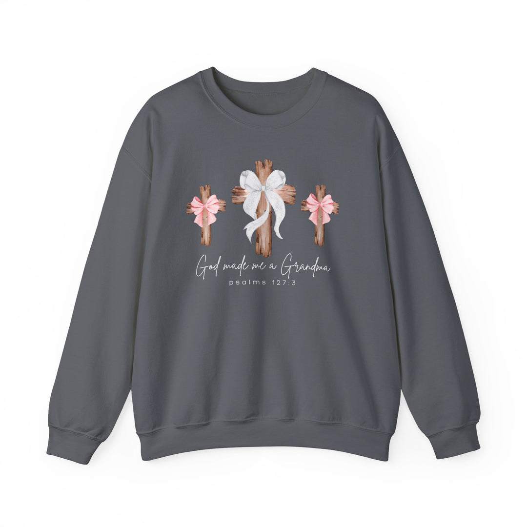 Dark charcoal-gray sweatshirt with three wooden crosses and God Made Me a Grandma script, featuring a comfortable unisex fit from Faith Family Designs.