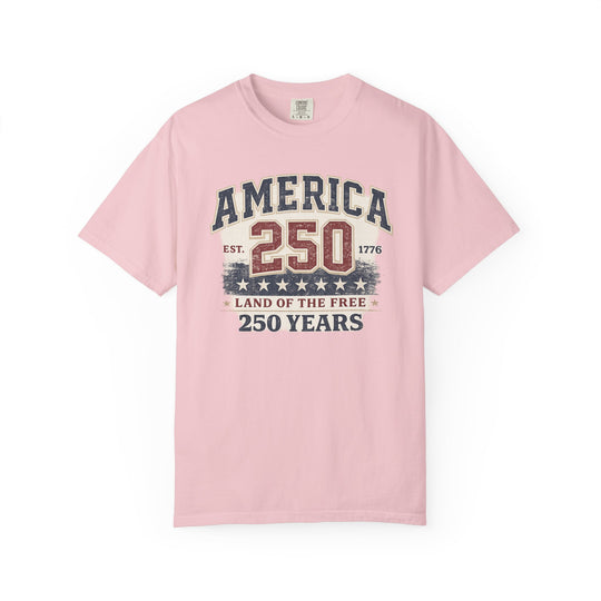 Light pink America 250 Years Tee with vintage graphic celebrating U.S. history, featuring distressed text and numbers, made from soft, durable, 100% ring-spun cotton.
