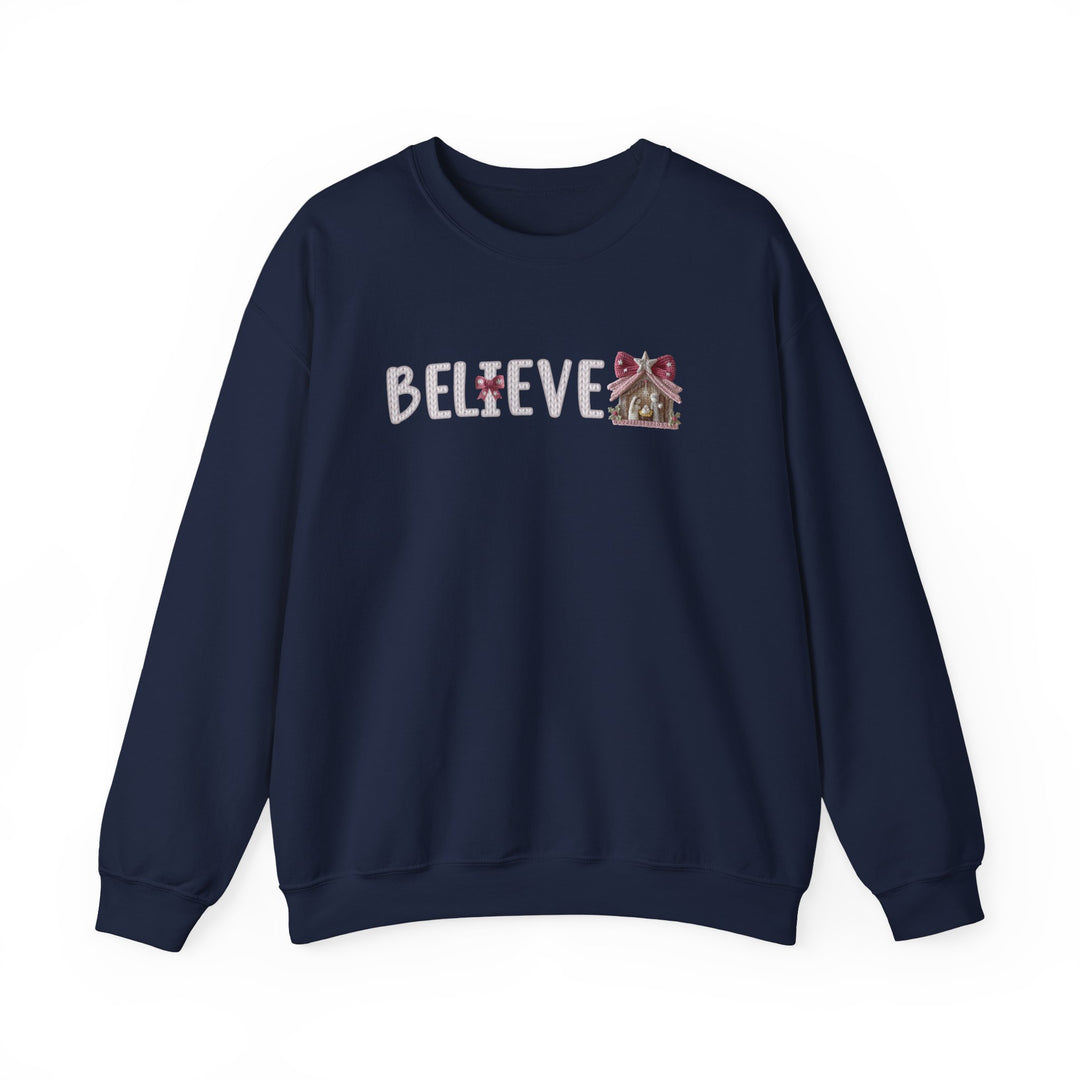 Navy-blue crewneck sweatshirt with BELIEVE in holiday-themed font, featuring bows and candy-striping, perfect for cozy, festive wear.
