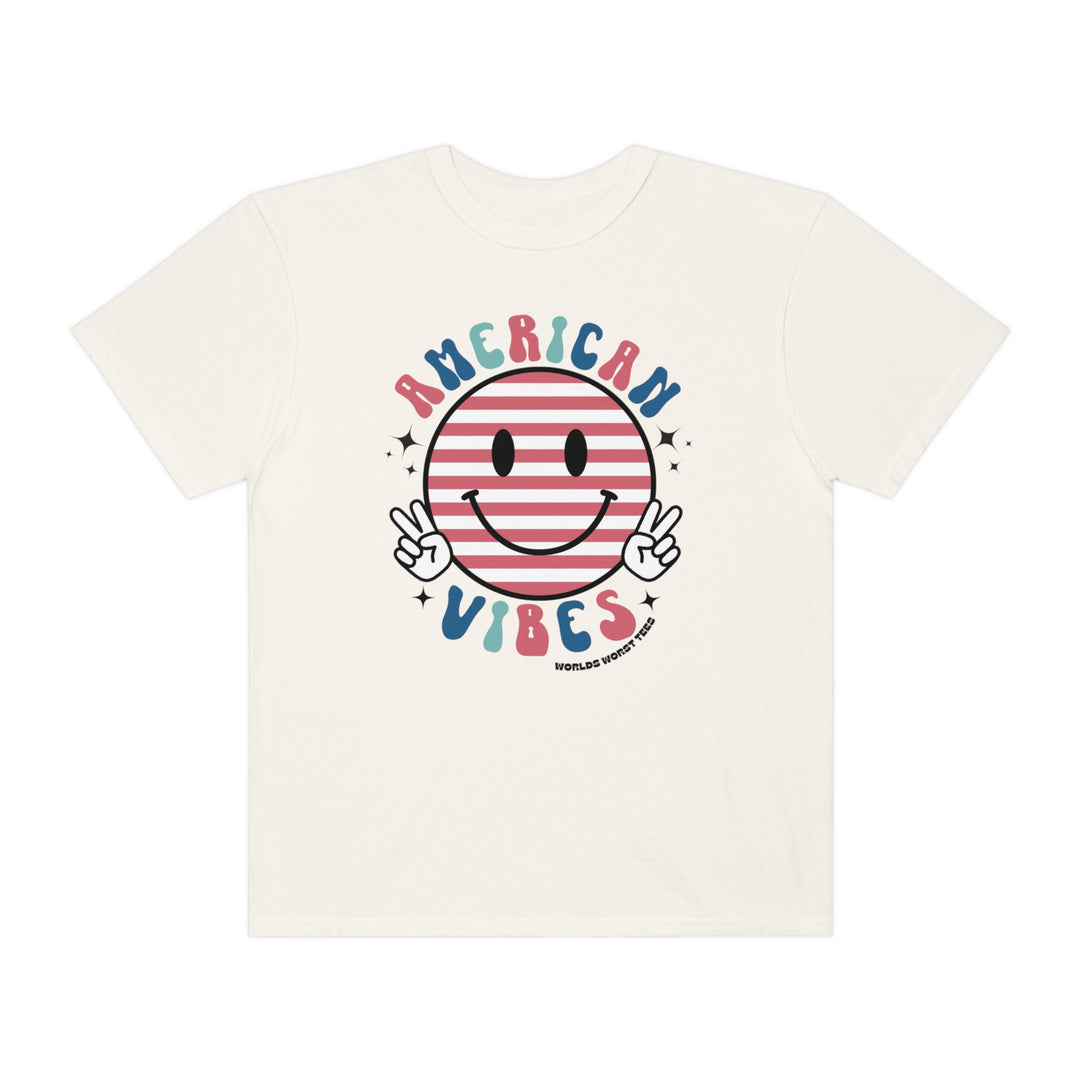 A relaxed fit American Vibes Tee, featuring a smiley face design on white cotton. Garment-dyed for coziness, with durable double-needle stitching and a seamless finish. Made for everyday comfort.