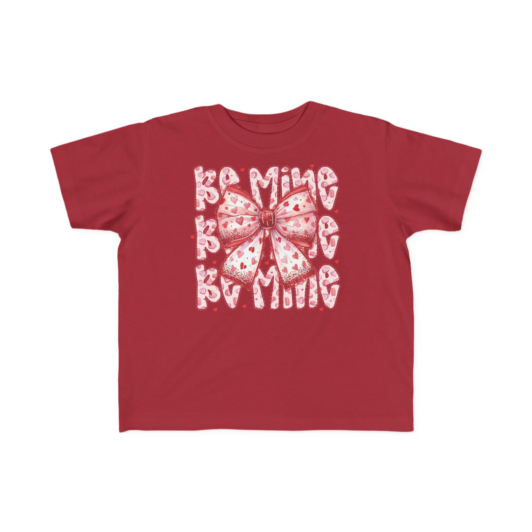 Be Mine Toddler Tee featuring a pink-and-white heart bow graphic with Be Mine text, perfect for sensitive skin in classic fit, ideal for toddlers.