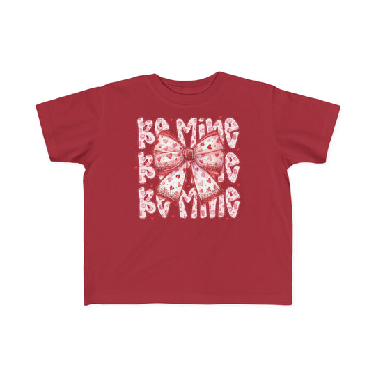 Be Mine Toddler Tee featuring a pink-and-white heart bow graphic with Be Mine text, perfect for sensitive skin in classic fit, ideal for toddlers.