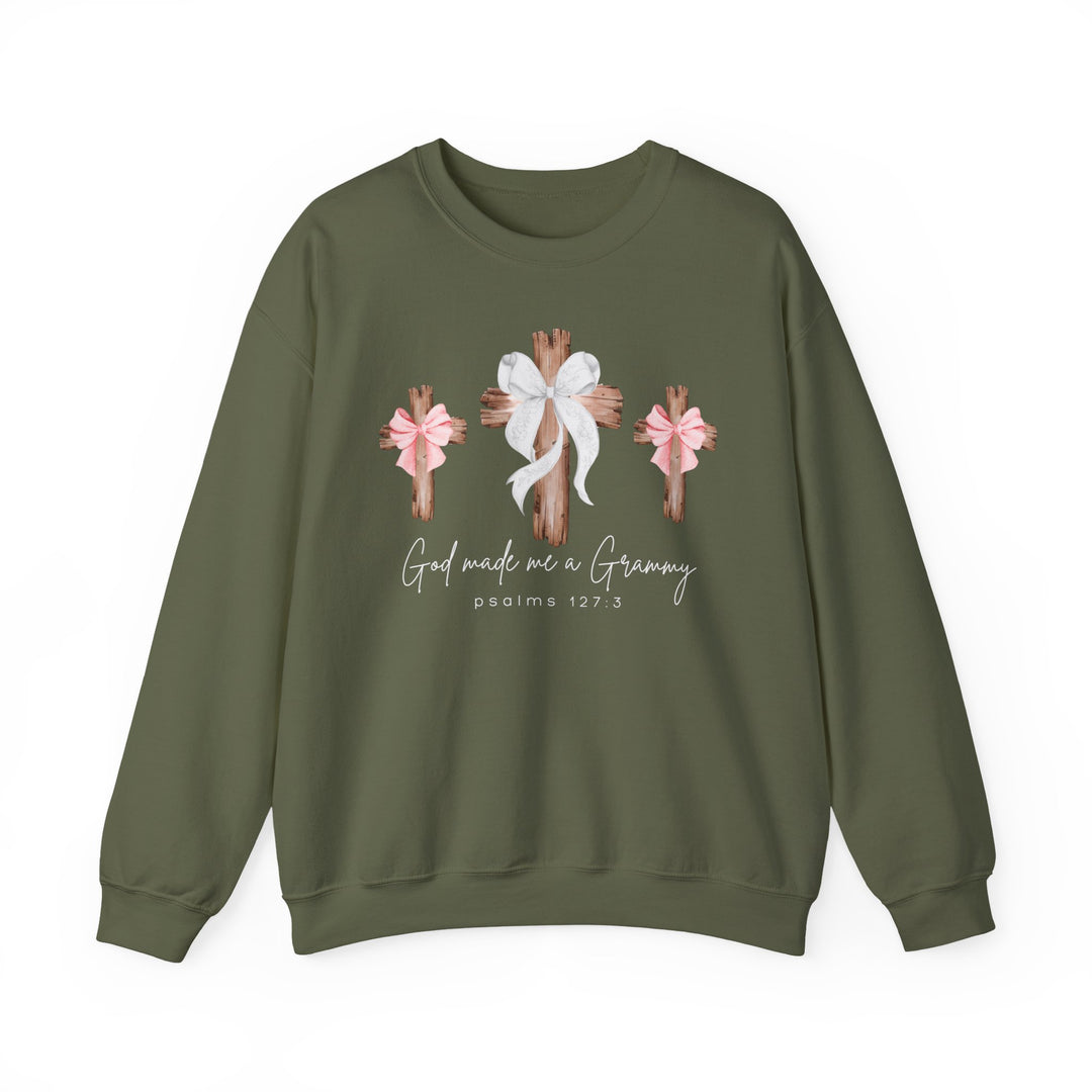 Olive-green crewneck sweatshirt with rustic wooden crosses, bows, and 'God Made Me a Grammy' text, blending comfort with faith-inspired design.