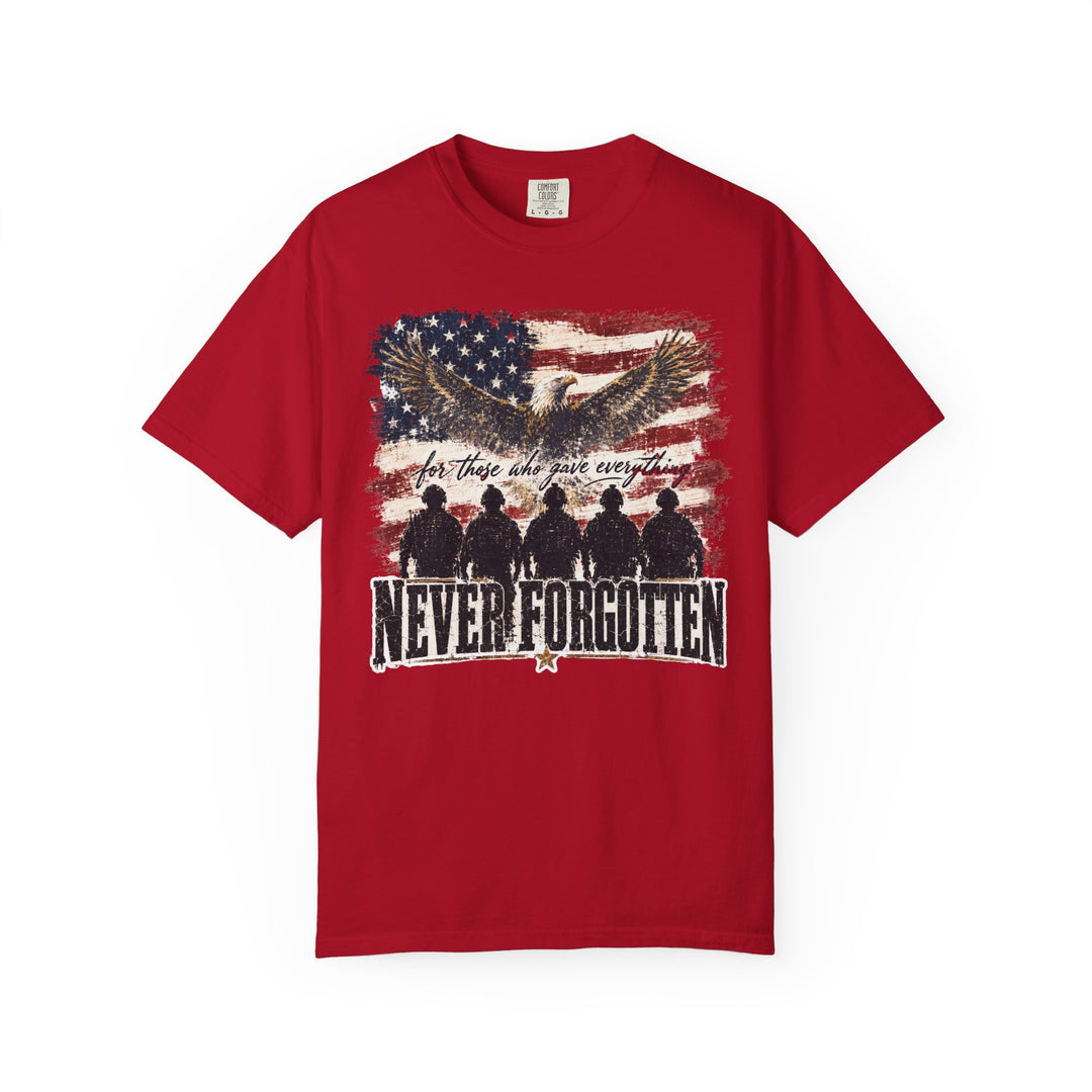 Never Forgotten Tee featuring a distressed American flag backdrop, soaring bald eagle, and kneeling soldier silhouettes. Made from soft, durable 100% ring-spun cotton.