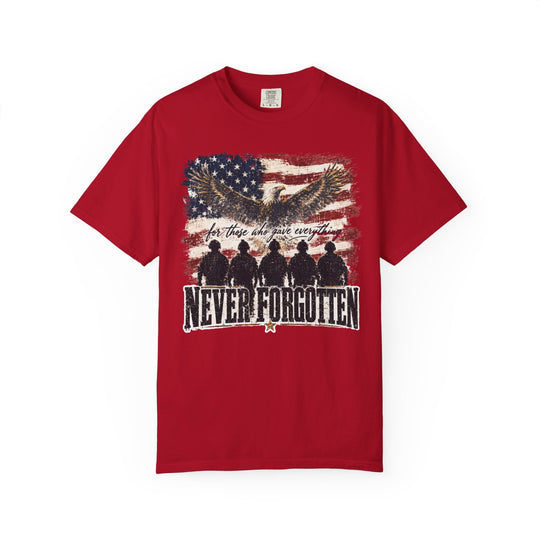 Never Forgotten Tee featuring a distressed American flag backdrop, soaring bald eagle, and kneeling soldier silhouettes. Made from soft, durable 100% ring-spun cotton.