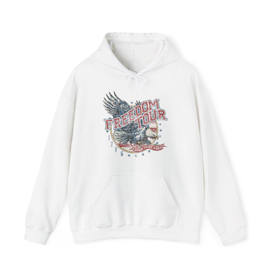 A white Freedom Tour Hoodie, a blend of cotton and polyester, featuring a graphic design and logo. Unisex, heavy fabric with kangaroo pocket and drawstring hood. Classic fit, tear-away label, sizes S-5XL.