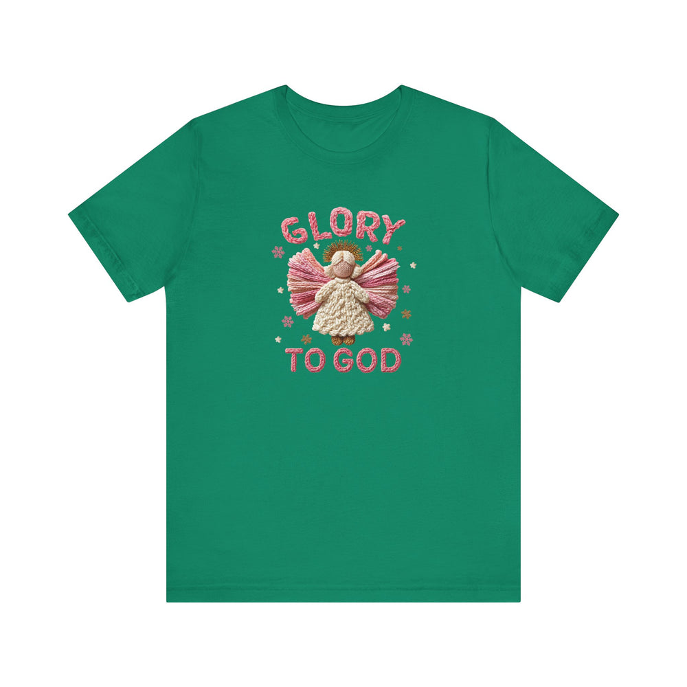 Green Glory to God Tee featuring a yarn-like angel graphic with pink wings, cream gown, and golden halo, surrounded by star shapes, emphasizing holiday spirit.
