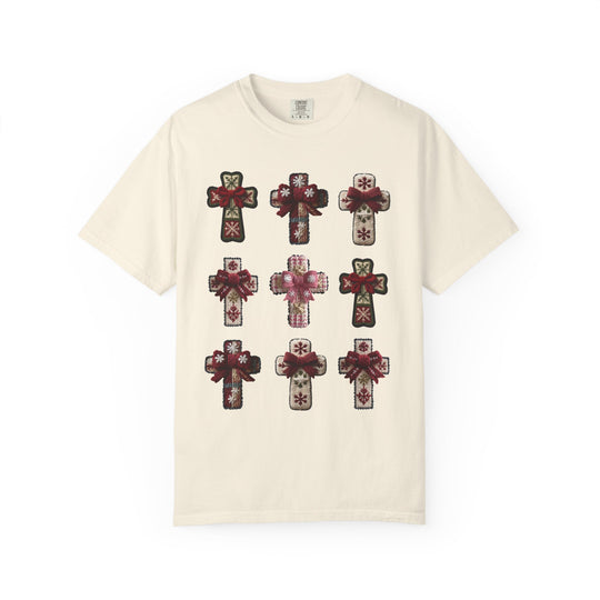 Crosses Tee featuring a 3x3 grid of decorative, holiday-style crosses with red bows on a light-cream T-shirt, embodying stylish comfort from Faith Family Designs.
