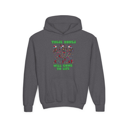Bones Come to Life Youth Hoodie features dancing skeletons in Santa hats with Christmas lights, bold green lettering, kangaroo pocket, and ribbed cuffs.