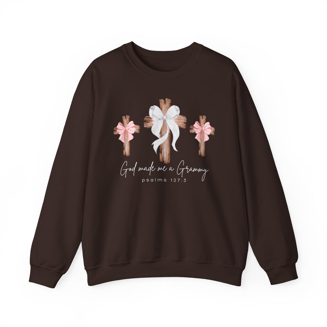 Dark-brown sweatshirt with God Made Me a Grammy and three crosses graphic, featuring bows. Comfortable polyester-cotton blend, ribbed collar, loose fit.