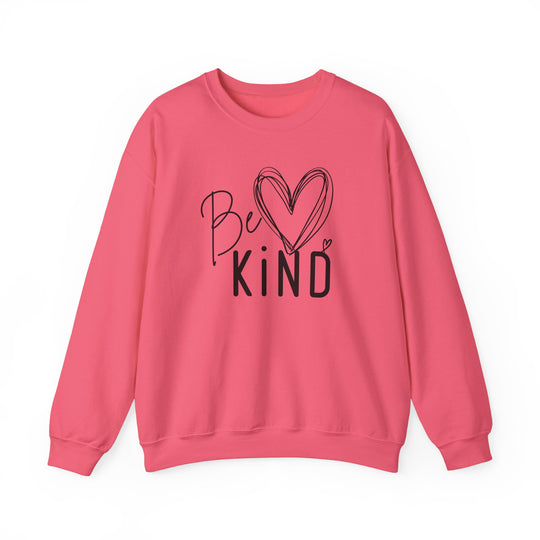 Pink crew-neck sweatshirt with “Be ♥ KiND” design in black, ideal for comfort and durability, crafted from a cotton-polyester blend by Faith Family Designs.