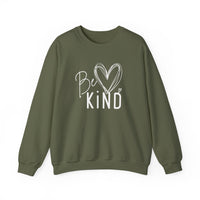 Army-green crewneck sweatshirt with “Be Kind” and heart graphic. Cozy, durable, and ethically made for Faith Family Designs.