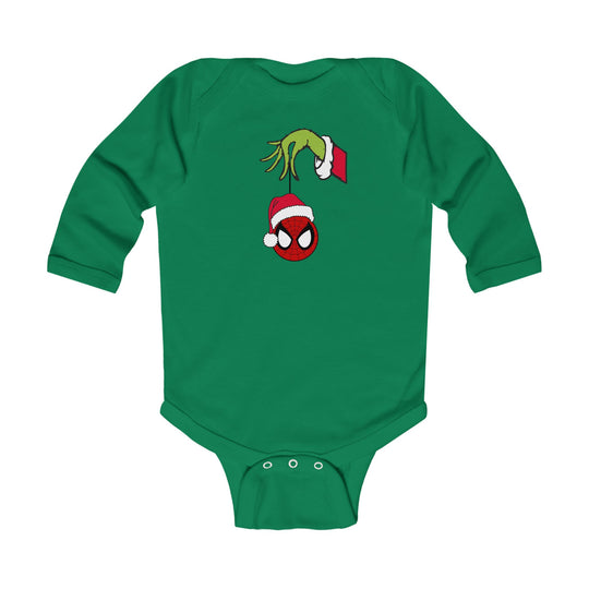 Spider Ball Christmas Onesie: A green baby onesie featuring a Grinch-like hand holding a Spider-Man ornament with a Santa hat, designed for comfort and easy changing.
