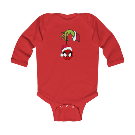 Spider Ball Christmas Onesie: Red baby bodysuit with Grinch hand holding a Spider-Man ornament, featuring Santa hat. Soft, durable cotton with easy-change snaps.