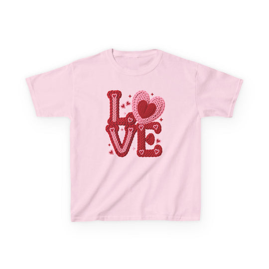 Light-pink kids tee with “LOVE” in red and pink yarn letters; heart-shaped O and decorative hearts and sparkles.