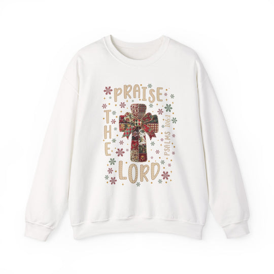 Praise the Lord Crew, a cozy white sweatshirt featuring a patchwork cross with a bow, snowflakes, stars, and PSALMS 106:1 text.
