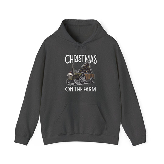 Christmas at the Farm Hoodie featuring a festive tractor and Christmas tree graphic, ideal for warmth and style in cold weather.