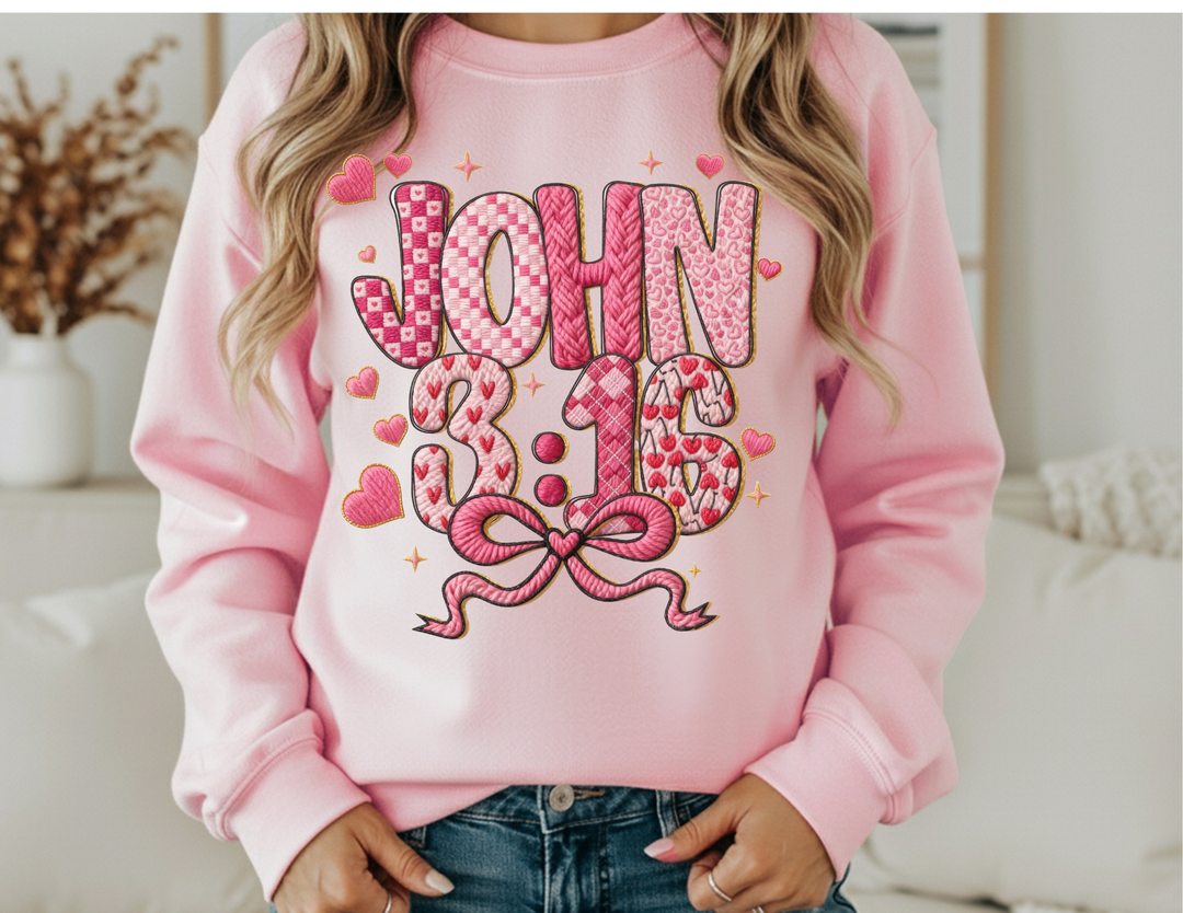Person wearing the 3:16 Crew sweatshirt with JOHN 3:16 in heart-patterned letters, highlighting comfort and style from Faith Family Designs.