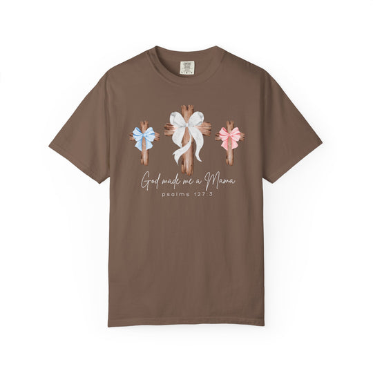 Brown “God Made Me a Mama” T-shirt with rustic wooden cross graphics and bows, featuring a Christian motherhood theme and Psalms 127:3 reference.