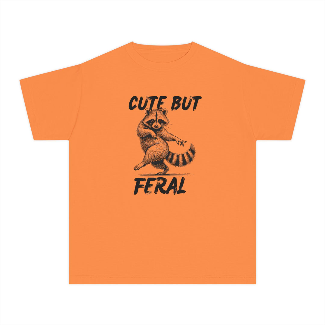 Cute but Feral Kids Tee featuring a stylized raccoon illustration with bold lettering, designed for comfort and agility in a classic fit for active kids.
