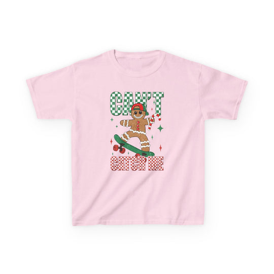 Can't Catch Me Kids Tee features a gingerbread cookie on a skateboard, wearing a festive cap, and holding a candy cane, with playful checkerboard text.