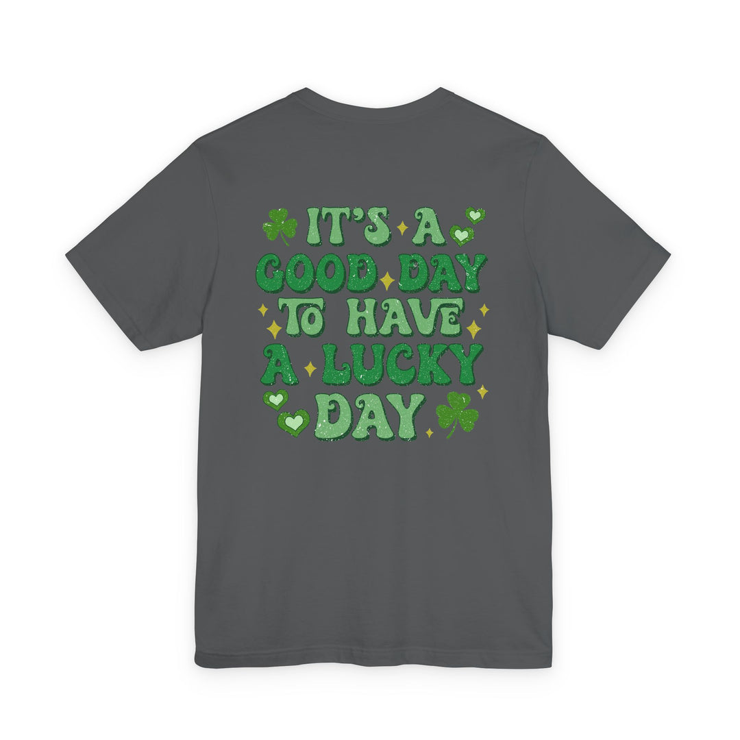Dark gray T-shirt featuring green glitter-style text reading “It’s a good day to have a lucky day” with shamrocks and hearts, St. Patrick’s Day themed graphic