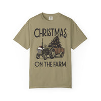 Christmas on the Farm Tee with vintage tractor and decorated tree, festive design on khaki Comfort Colors T-shirt, capturing holiday spirit.