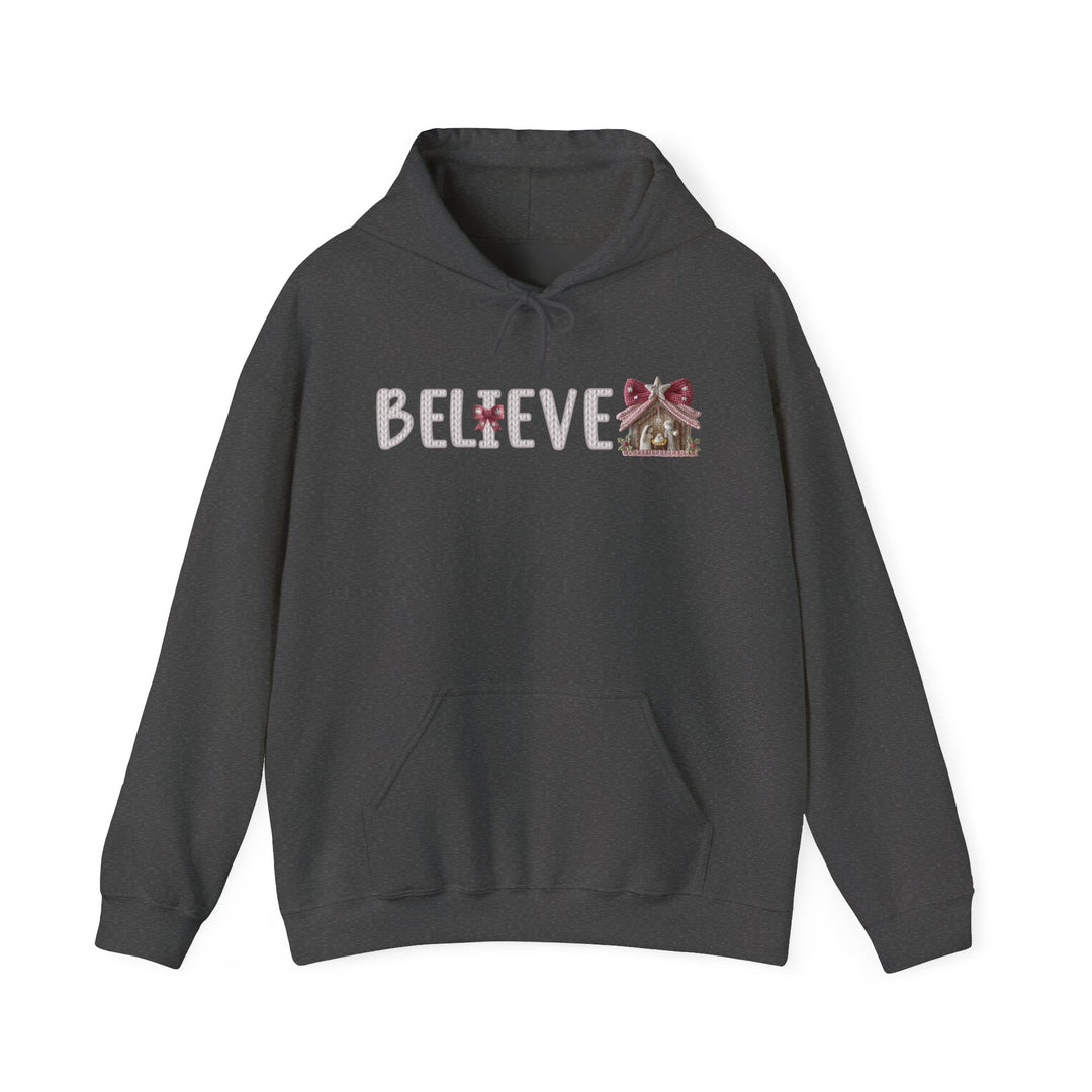 Dark charcoal-gray Believe Hoodie with a pouch pocket, featuring a holiday graphic and gingerbread-themed lettering, perfect for cozy, stylish comfort.