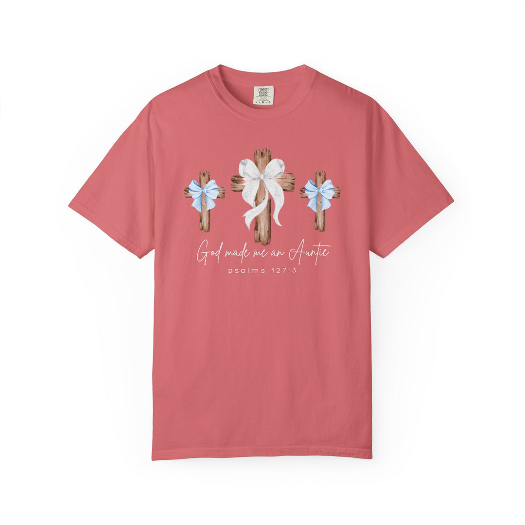 God Made Me an Auntie Tee features three wooden crosses with bows, script text, and a Bible verse, on a coral-pink Comfort Colors t-shirt.