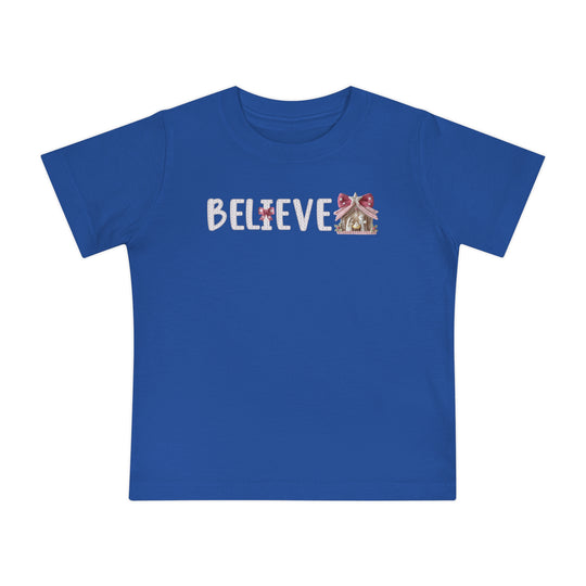Believe Baby Tee: Bright blue T-shirt featuring BELIEVE with a gingerbread-house motif, designed for comfort and durability in soft, pre-shrunk cotton.