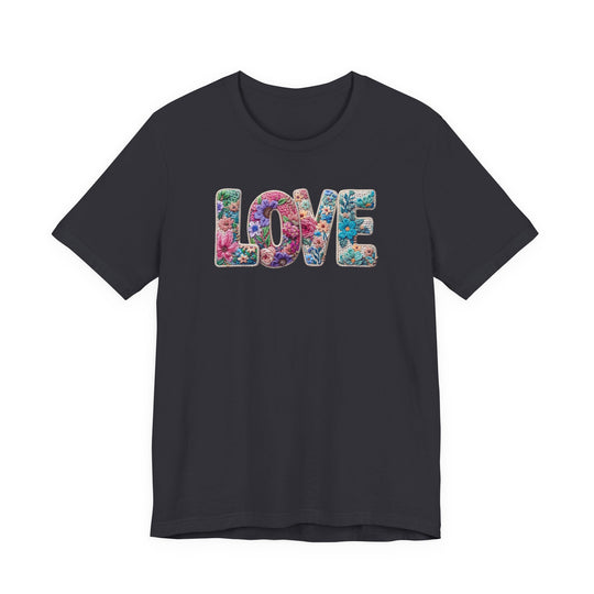 Love Spring Tee with LOVE in floral motif on charcoal T-shirt, highlighting vibrant blossoms. Unisex fit, soft cotton, ribbed collar, and durable seams.