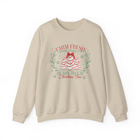 Cream-colored crewneck sweatshirt with festive Farm Fresh Cookies Crew graphic of frosting trees, red bow, wreath accents, and snowflakes. Cozy, durable, and stylish.