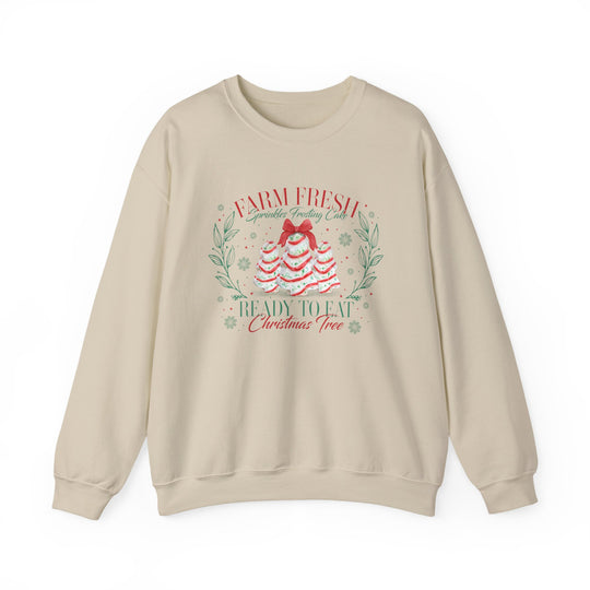 Cream-colored crewneck sweatshirt with festive Farm Fresh Cookies Crew graphic of frosting trees, red bow, wreath accents, and snowflakes. Cozy, durable, and stylish.
