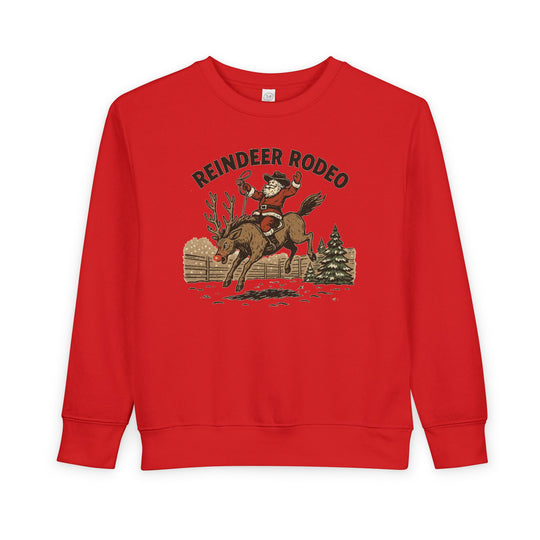 Reindeer Toddler Crew: Red sweatshirt with Santa as a cowboy on a reindeer, REINDEER RODEO text, cozy fleece blend for toddlers.
