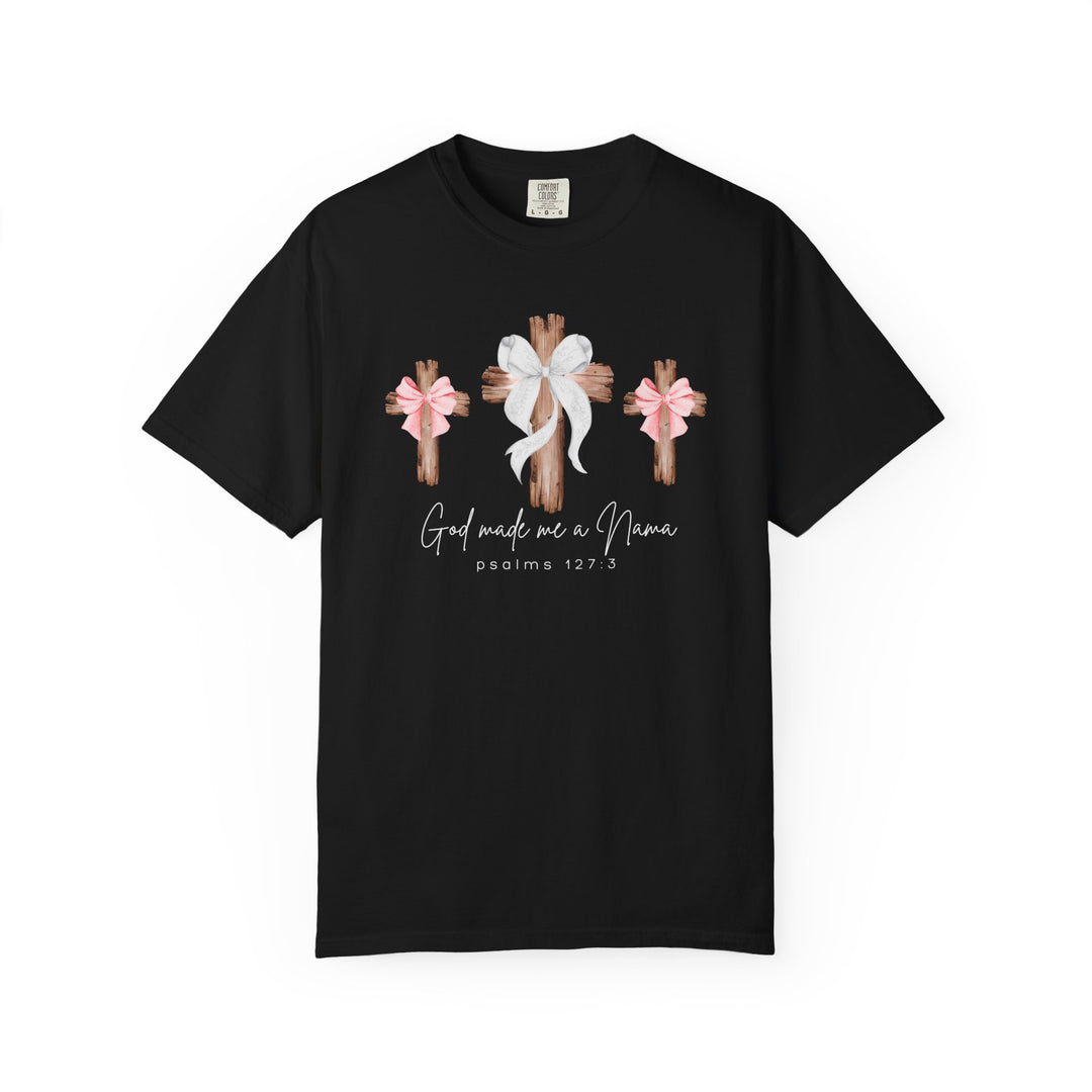 Black 'God Made Me a Nana' T-shirt features rustic wooden crosses with bows and Psalm 127:3, offering a cozy, faith-inspired design.