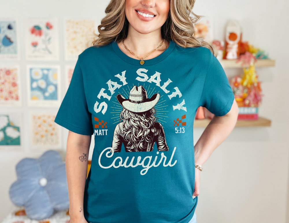 Smiling woman wearing a Stay Salty Tee, showcasing its soft, comfortable fit and quality design with ribbed knit collars and taped shoulders for durability.