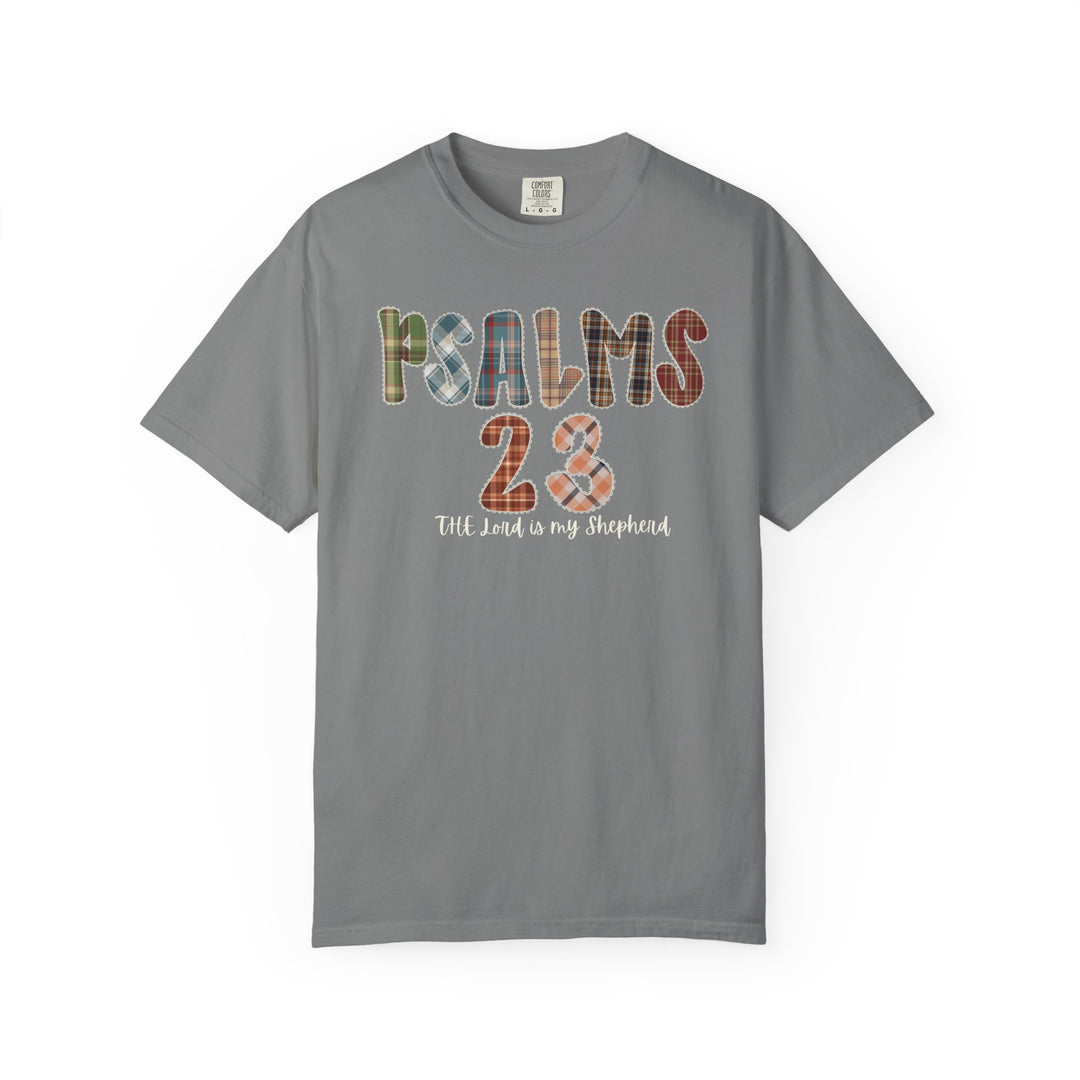 Psalms 23 Tee: A gray T-shirt with PSALMS 23 in plaid letters and The Lord is my Shepherd script, offering a stylish faith-inspired design.