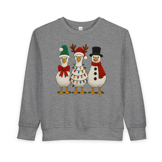 Christmas Geese Toddler Crew sweatshirt featuring three festive cartoon geese in holiday attire, perfect for keeping toddlers warm and stylish.