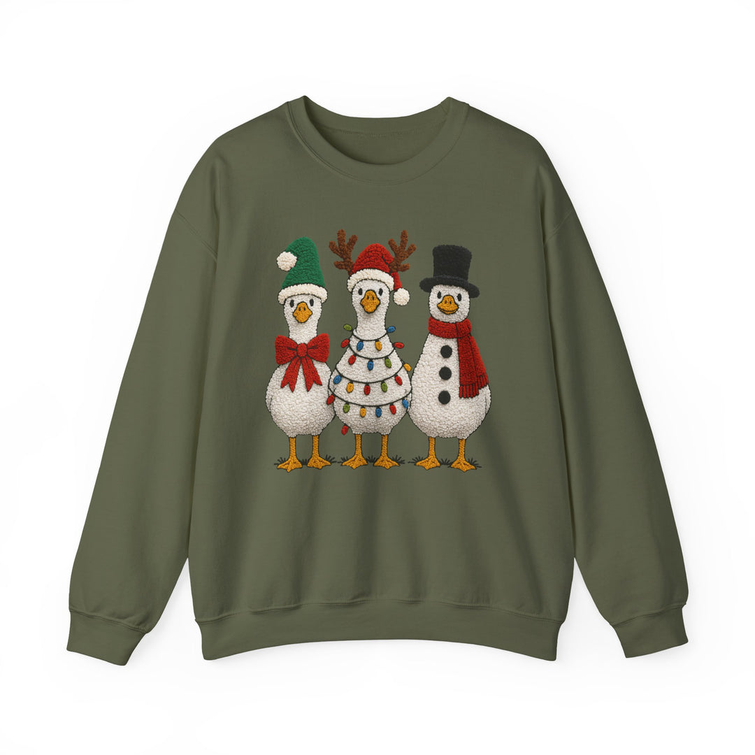 Olive-green crewneck sweatshirt with whimsical holiday geese graphic: Santa goose, reindeer goose with lights, and snowman goose. Cozy, unisex fit, ideal for colder months.