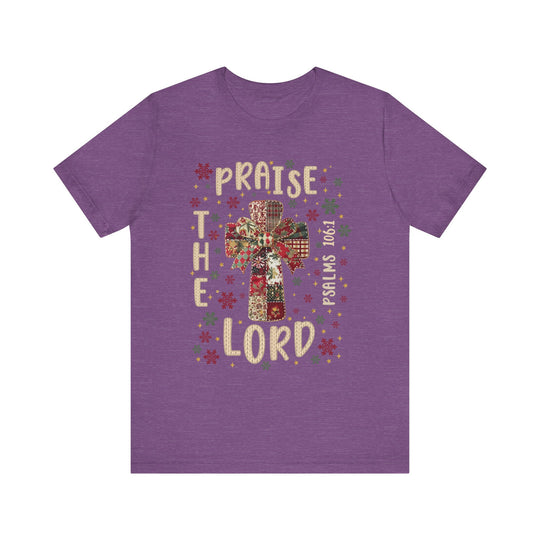 Praise the Lord Tee with patchwork cross, bow, and snowflake motifs; features Bible reference Psalms 106:1, combining faith-inspired design with comfortable unisex fit.