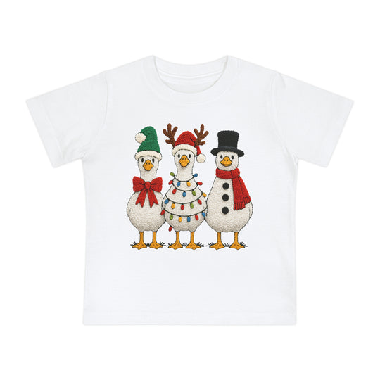 Christmas Geese Baby Tee featuring three cartoon geese in festive holiday attire, perfect for baby’s first steps in style. Available in sizes 3-24 months.