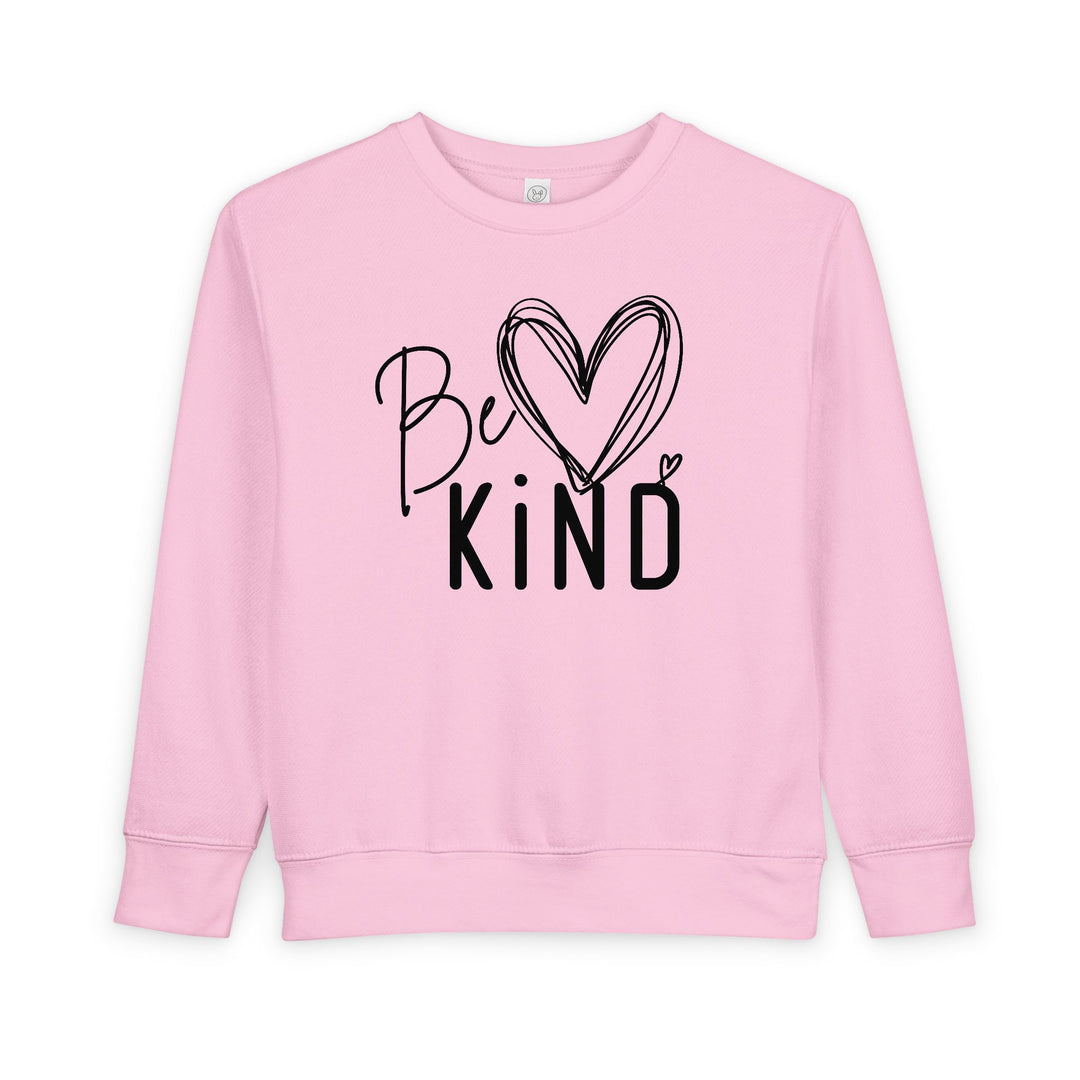 Light-pink Be Kind toddler crewneck sweatshirt, featuring mixed lettering and a heart design, made from a cozy cotton-polyester blend for comfort and durability.