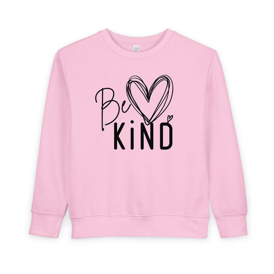 Light-pink Be Kind toddler crewneck sweatshirt, featuring mixed lettering and a heart design, made from a cozy cotton-polyester blend for comfort and durability.