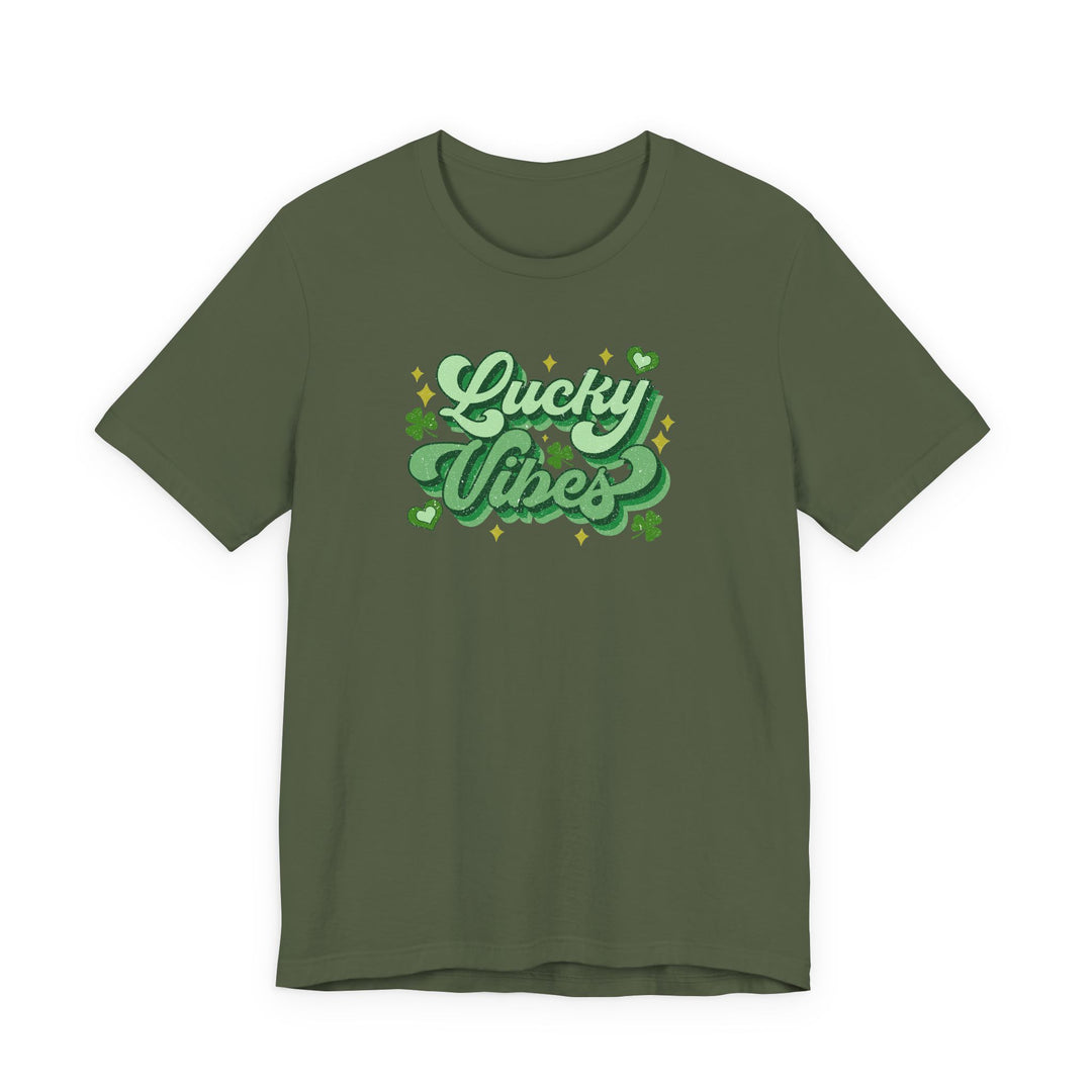 Olive-green Good Day Lucky Day Tee with Lucky Vibes slogan, sparkles, hearts, and shamrocks, offering a festive St. Patrick’s Day look in soft cotton.