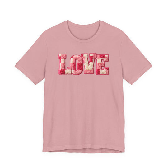 Light pink Love Tee with textured chenille-style LOVE in reds and pinks, showcasing a classic unisex design from Faith Family Designs.
