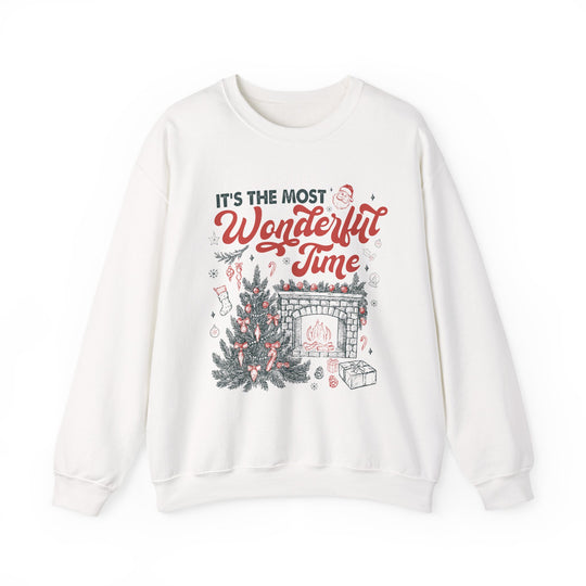 Most Wonderful Time of the Year Crew sweatshirt featuring a festive Christmas scene with a tree, fireplace, and Santa-accented text on a cozy white crew-neck.