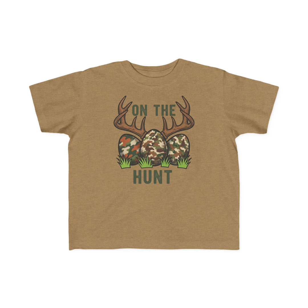 On the Hunt Toddler Tee featuring deer antlers, camouflage eggs, and grass. Soft cotton, perfect for toddlers. Available in sizes 2T to 5-6T.