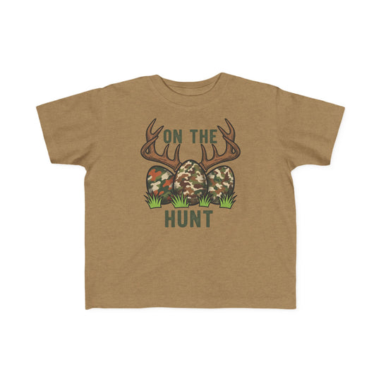 On the Hunt Toddler Tee featuring deer antlers, camouflage eggs, and grass. Soft cotton, perfect for toddlers. Available in sizes 2T to 5-6T.