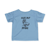 Cute but Feral Baby Tee featuring a cartoon raccoon and bold slogan, designed for comfort and durability with 100% combed cotton. Ideal for toddlers.